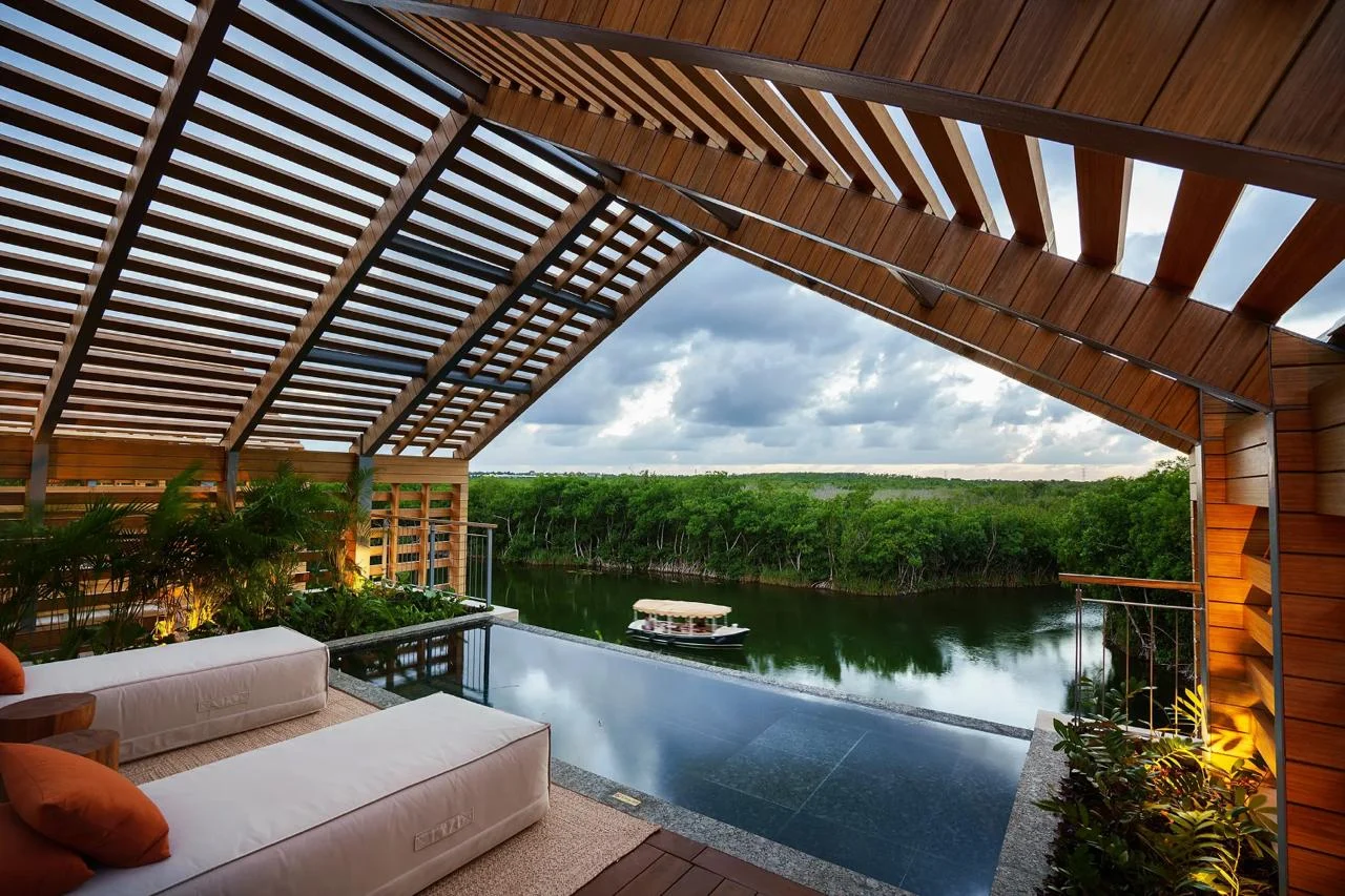 A pool terrace at Banyan Tree Mayakoba overlooking a tropical waterway