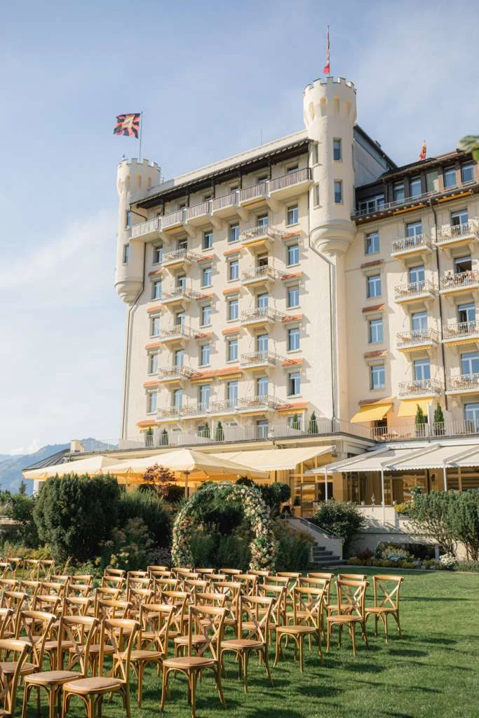 A wedding ceremony set before the Gstaad Palace facade