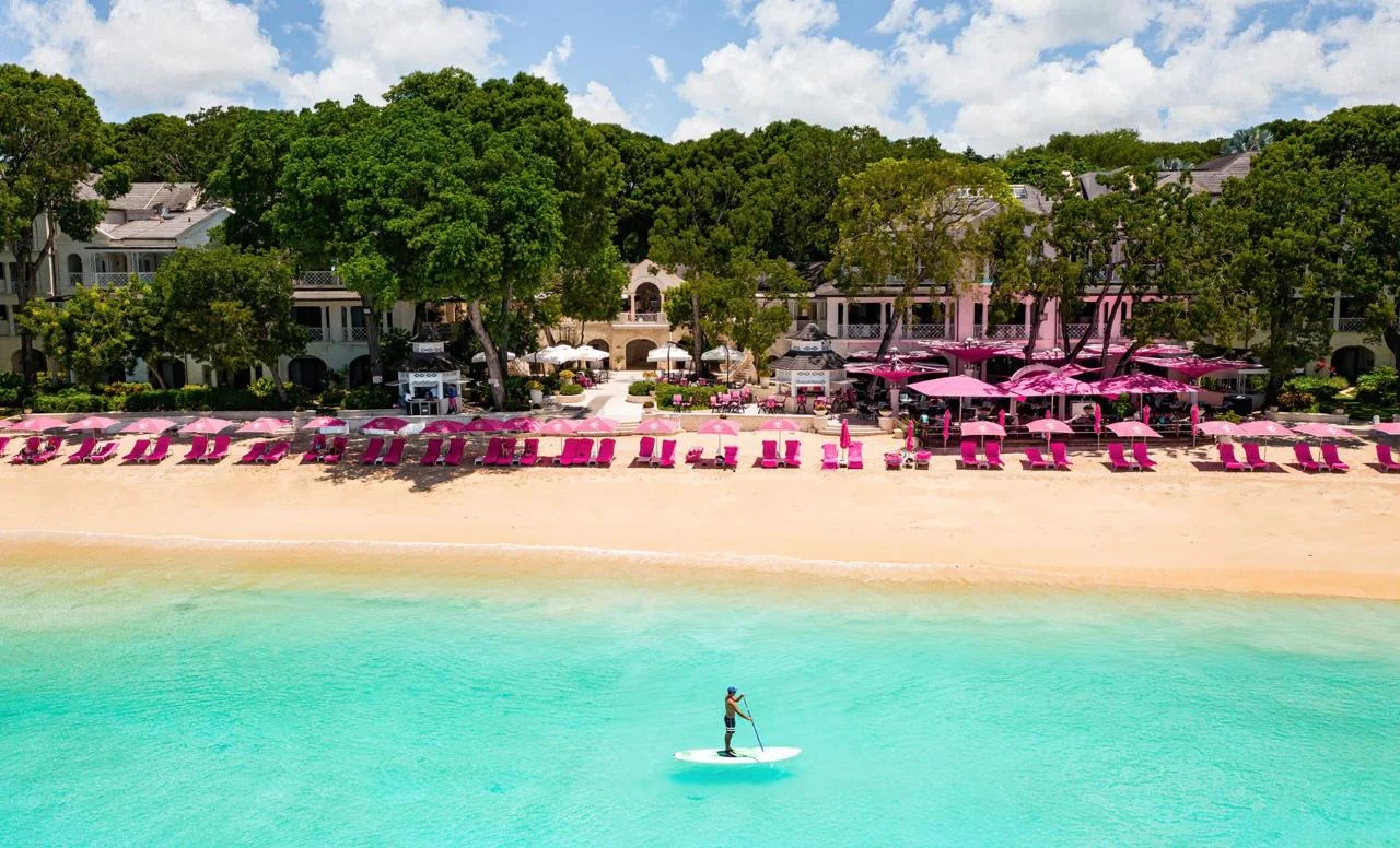 The beach at Sandy Lane Barbados with pink loungers and turquoise water